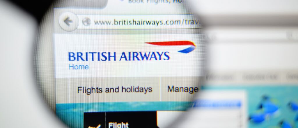 British Airways homepage on a monitor screen through a magnifying glass